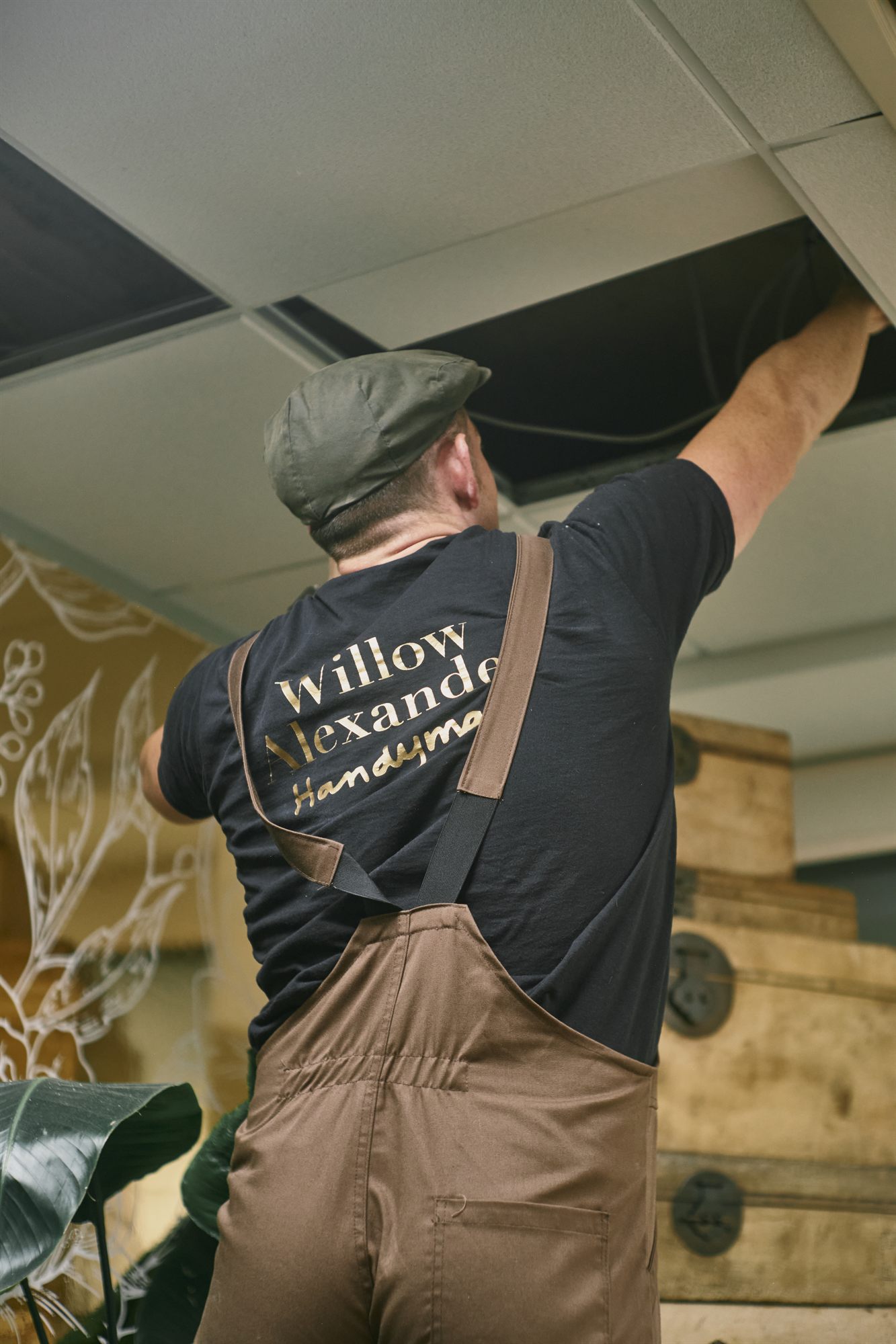 A Willow Alexander handyman preparing and painting a ceiling in a London home